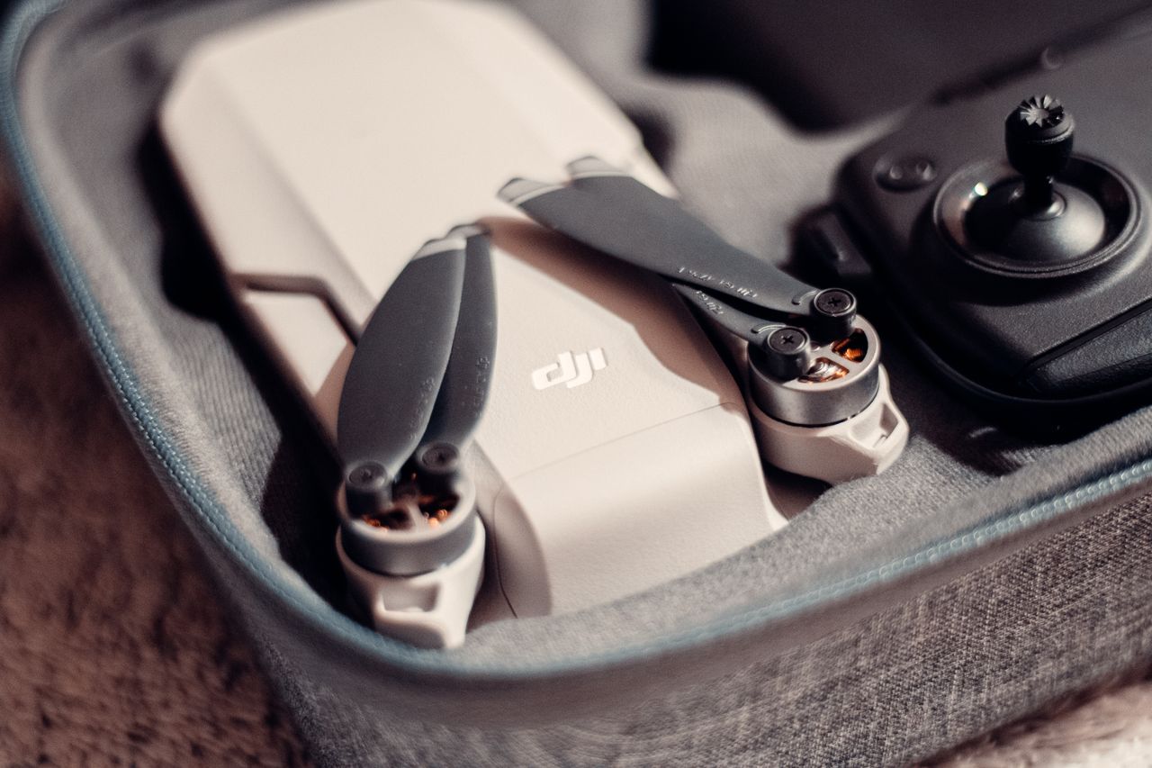 Services From above contemporary UAV and remote control placed in protective case on table